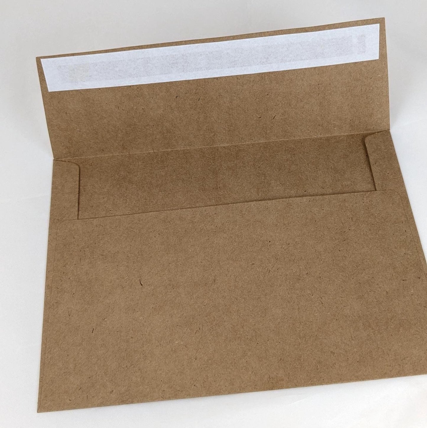 Brown self seal paper envelope on a white background